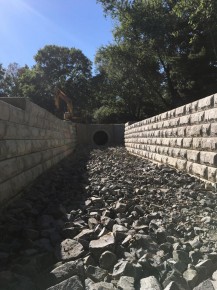 New Rip-Rap waterway channel w/ precast block retaining wall.